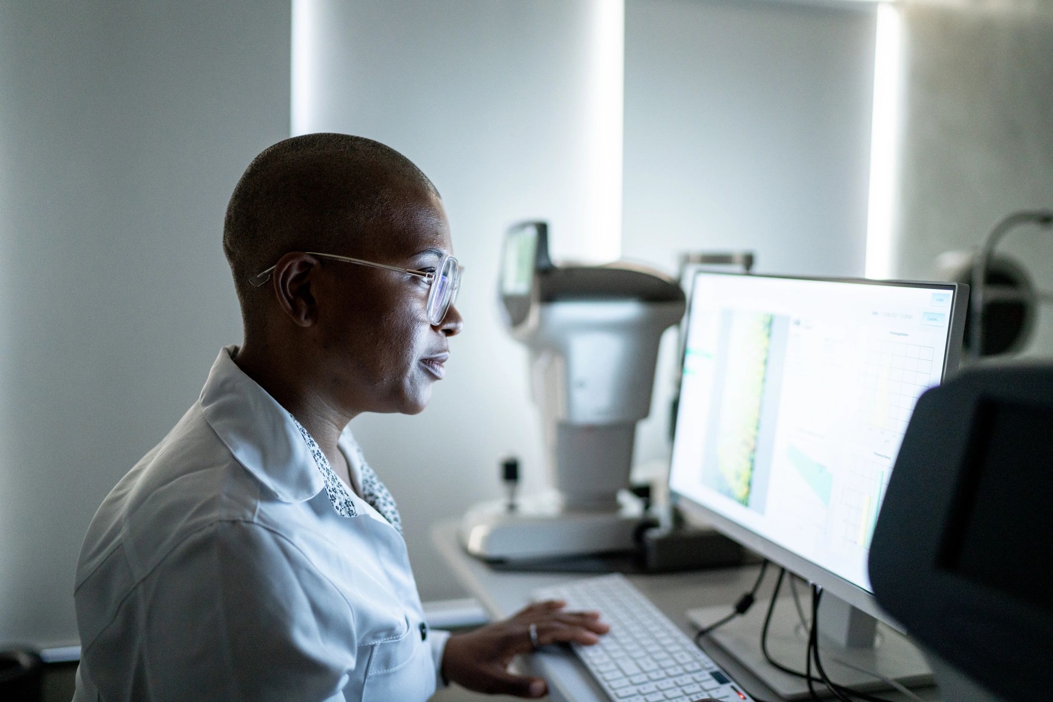 Professional reviewing data on a monitor