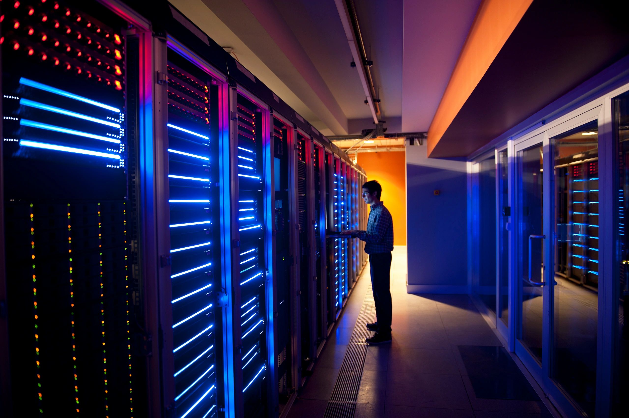 IT technician configuring servers in a server room